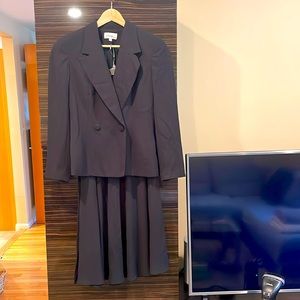 Tailored navy jacket and long skirt suit.